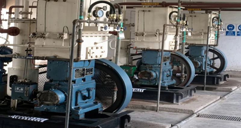 Acetylene compressor installed at dissolved acetylene cylinder filling station — Series A high-pressure twin-column three-stage reciprocating compressor with explosion-proof YB motor operating at 2.50 MPa for cylinder filling